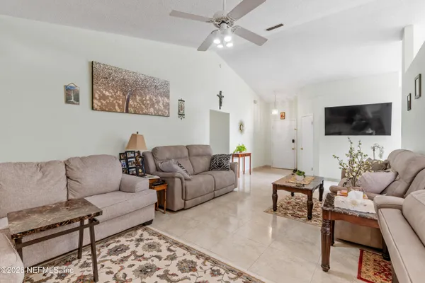 a living room with furniture and a flat screen tv