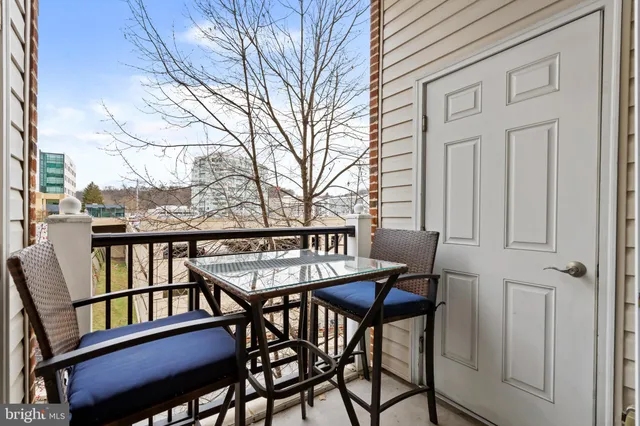 a view of a chairs and table in the balcony