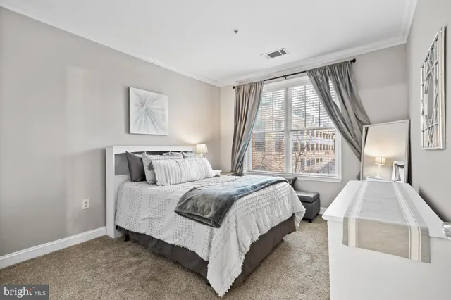 a bedroom with bed and a large window