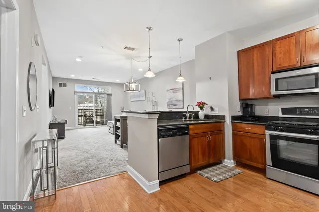 a kitchen with stainless steel appliances granite countertop a stove oven and a refrigerator