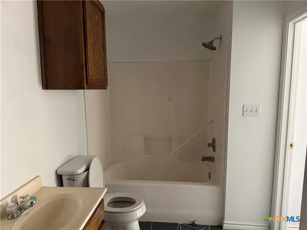 a bathroom with a toilet and a sink
