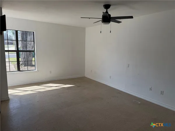 a view of empty room with windows
