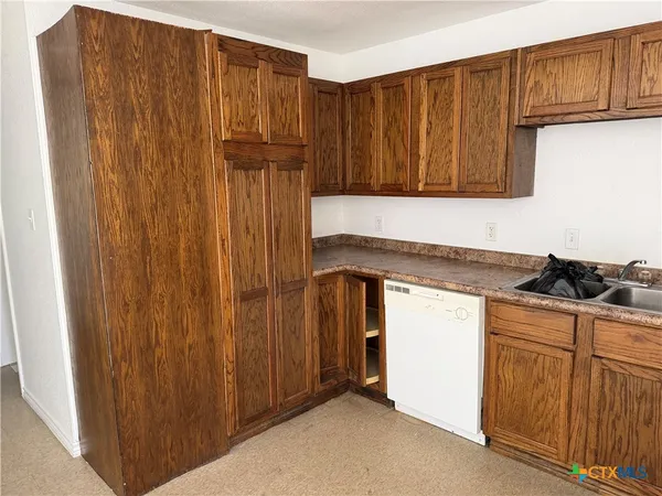 a kitchen with wooden cabinets