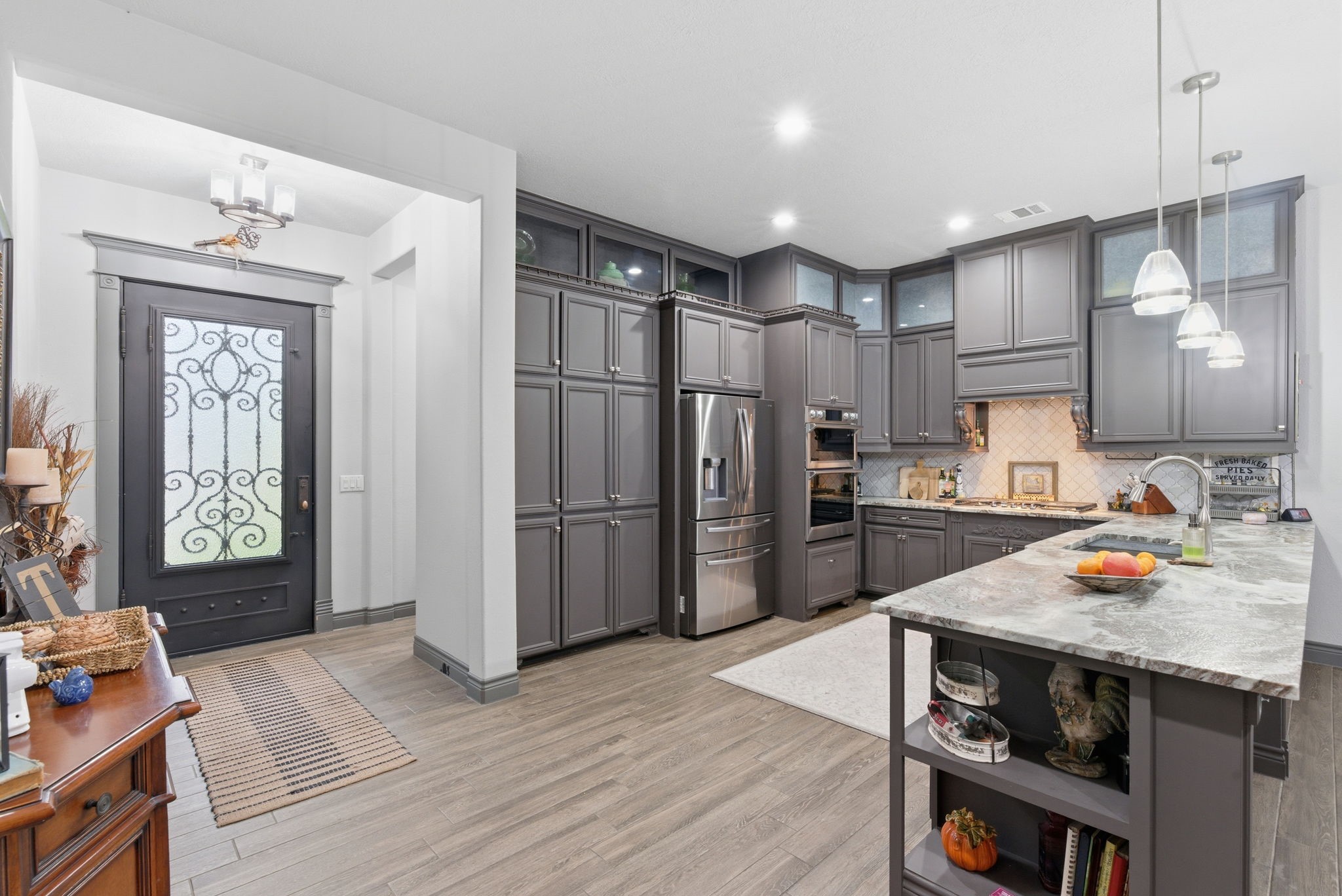 1480 Traylor Road Conroe, TX 77304 - Photo 7 of 25 a kitchen with stainless steel appliances a refrigerator and a stove top oven