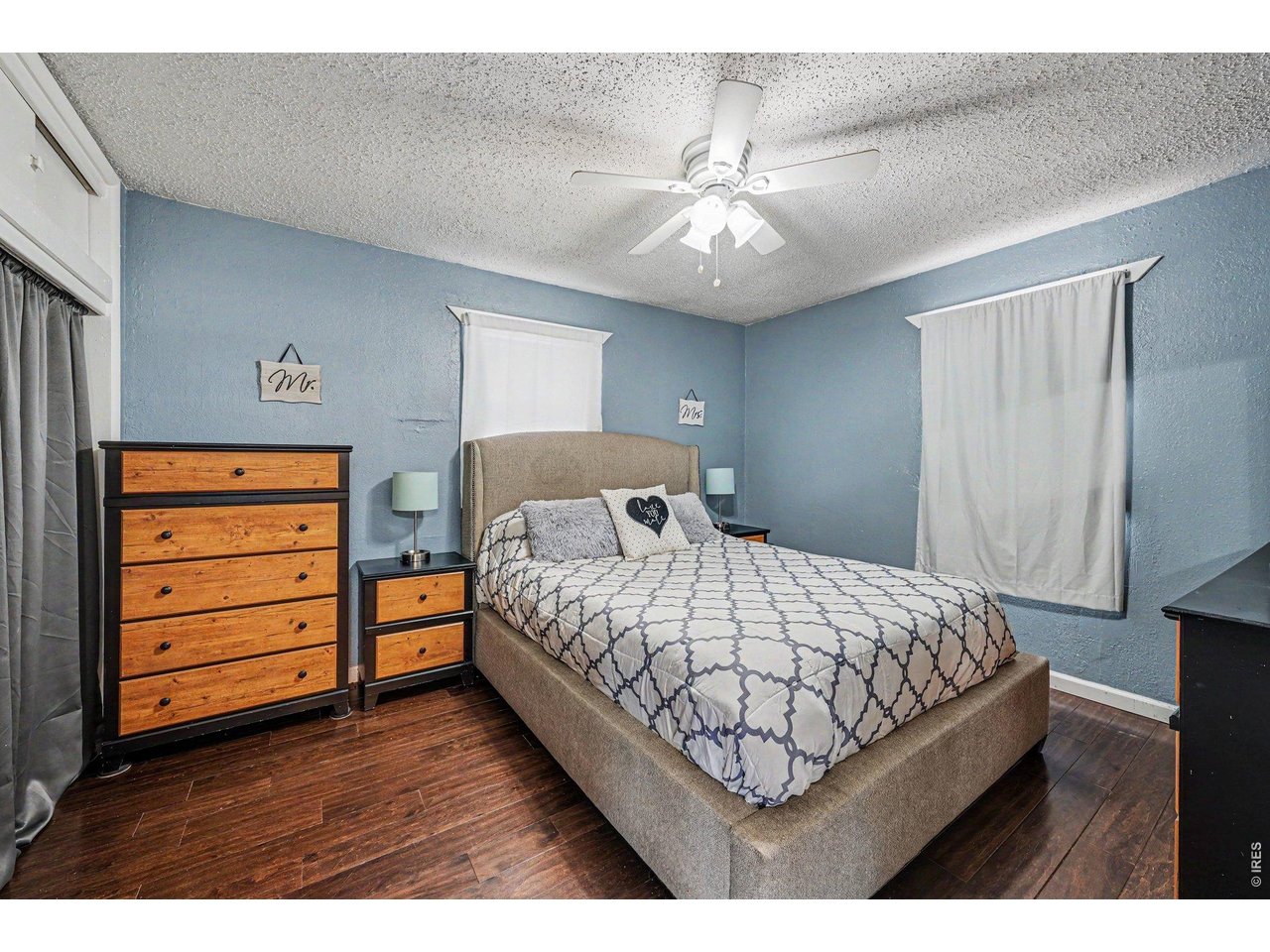 1430 30th Street Road Greeley, CO 80631 - Photo 11 of 22 a bedroom with a bed and a chandelier