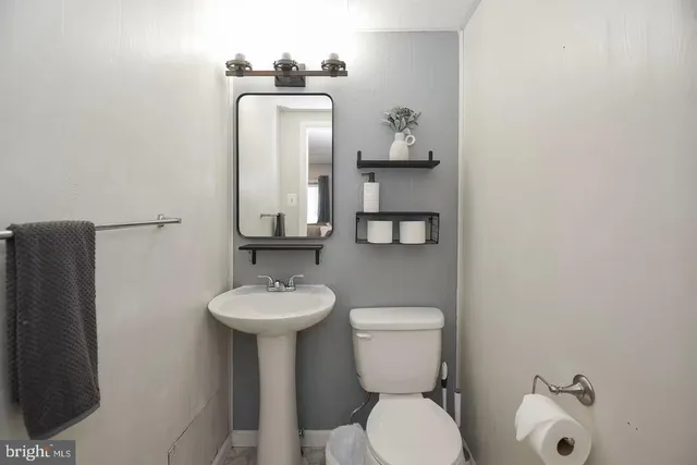 a bathroom with a toilet a sink and a window