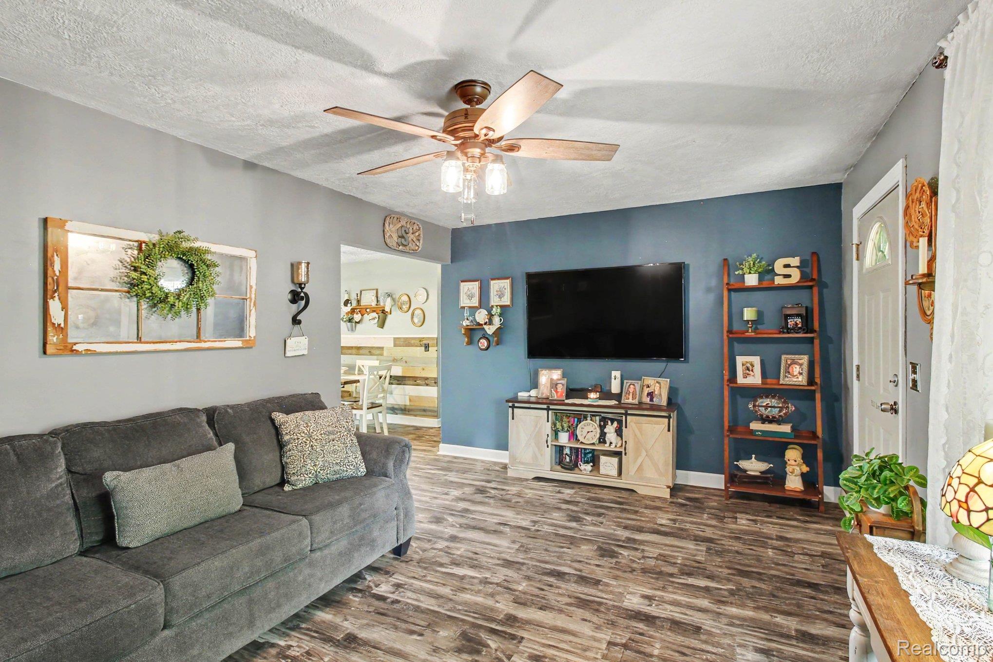 4623 West Lovejoy Road Byron, MI 48418 - Photo 5 of 21 Living area with dark wood-type flooring and ceiling fan
