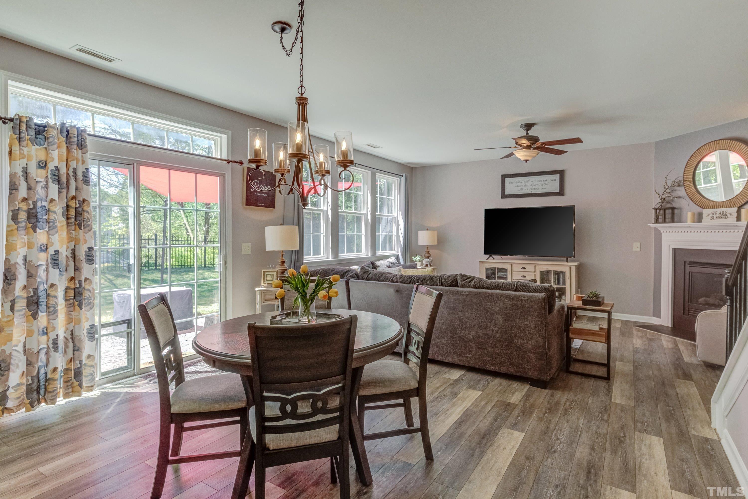 121 Ryder Cup Circle Raleigh, NC 27603 - Photo 13 of 43 a dining room with furniture a chandelier and wooden floor