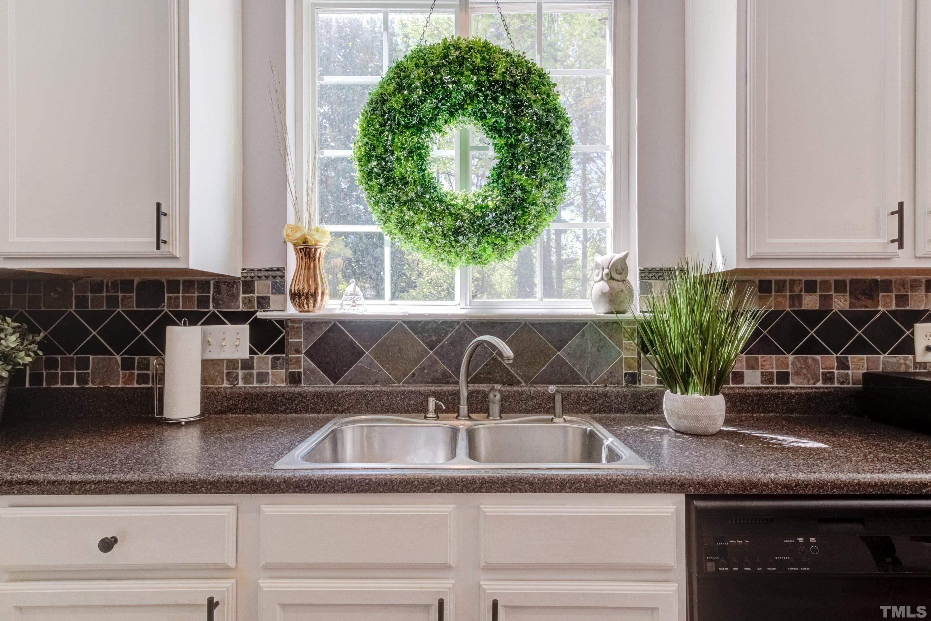 121 Ryder Cup Circle Raleigh, NC 27603 - Photo 17 of 43 a kitchen with a sink a counter and a window