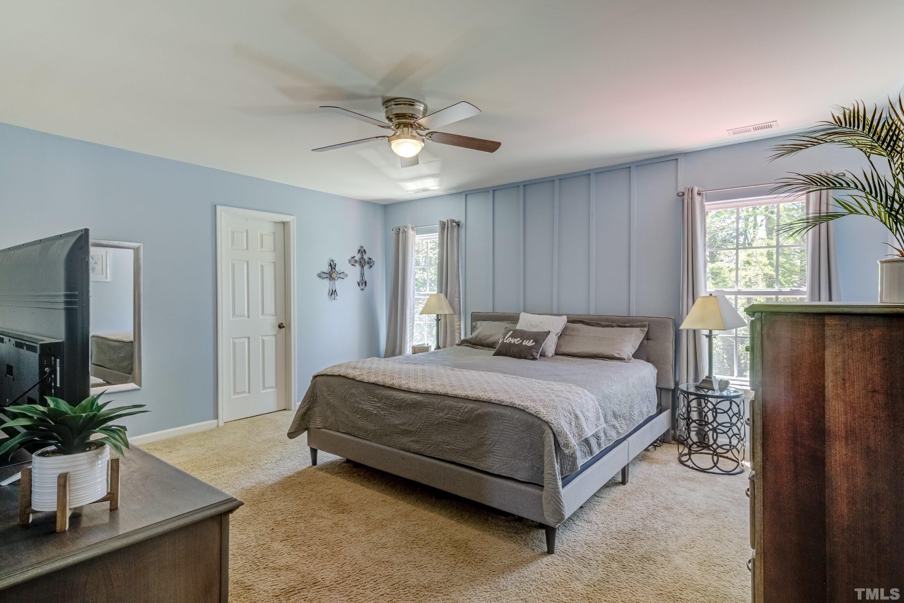 121 Ryder Cup Circle Raleigh, NC 27603 - Photo 23 of 43 a spacious bedroom with a bed and a chandelier