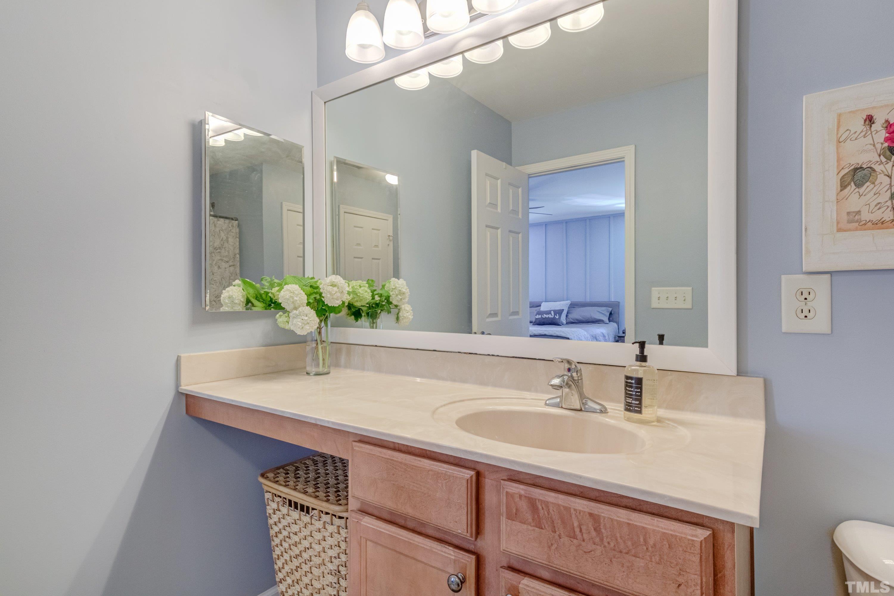121 Ryder Cup Circle Raleigh, NC 27603 - Photo 27 of 43 a bathroom with a sink and a mirror