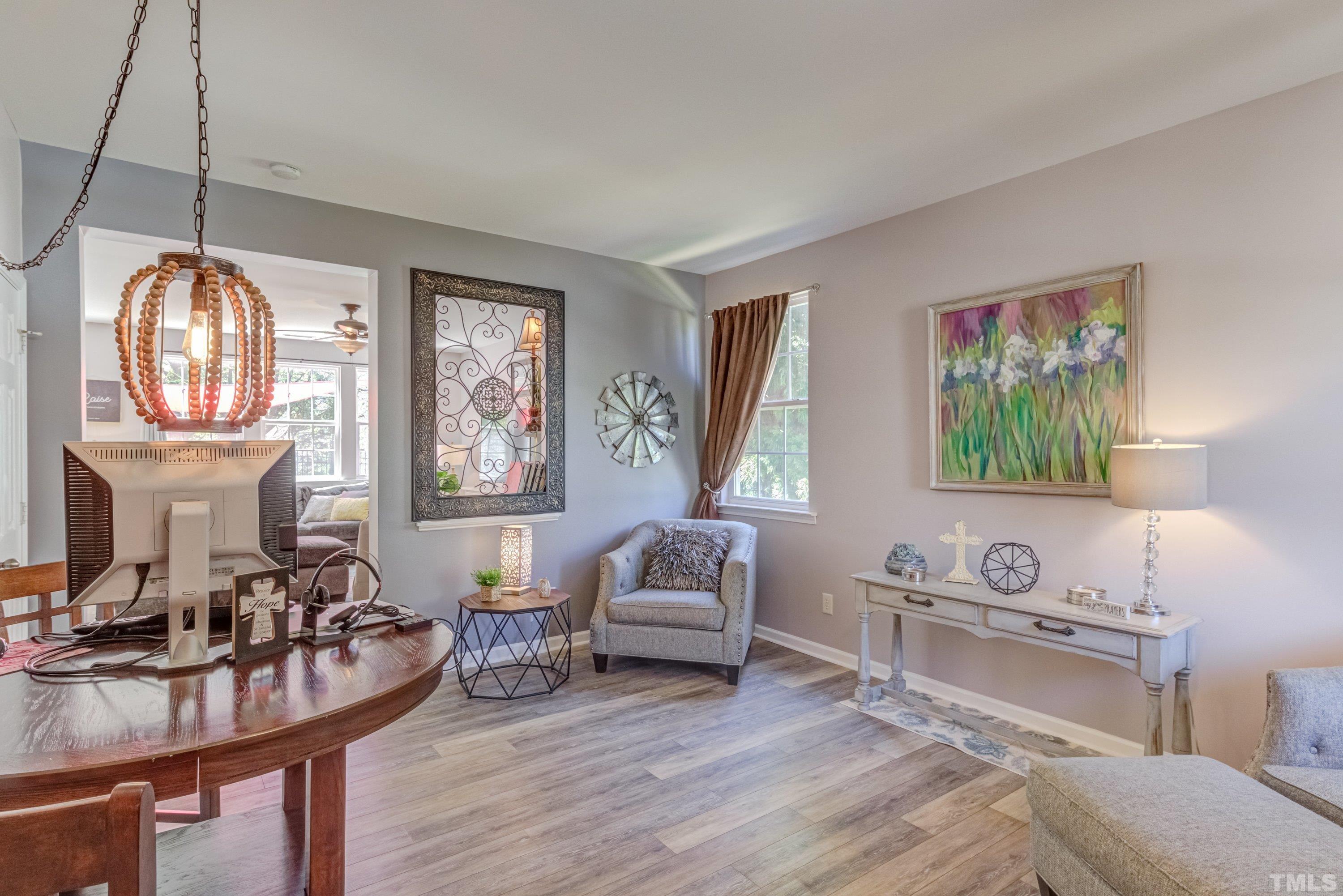 121 Ryder Cup Circle Raleigh, NC 27603 - Photo 4 of 43 a living room with furniture a fireplace and a floor to ceiling window