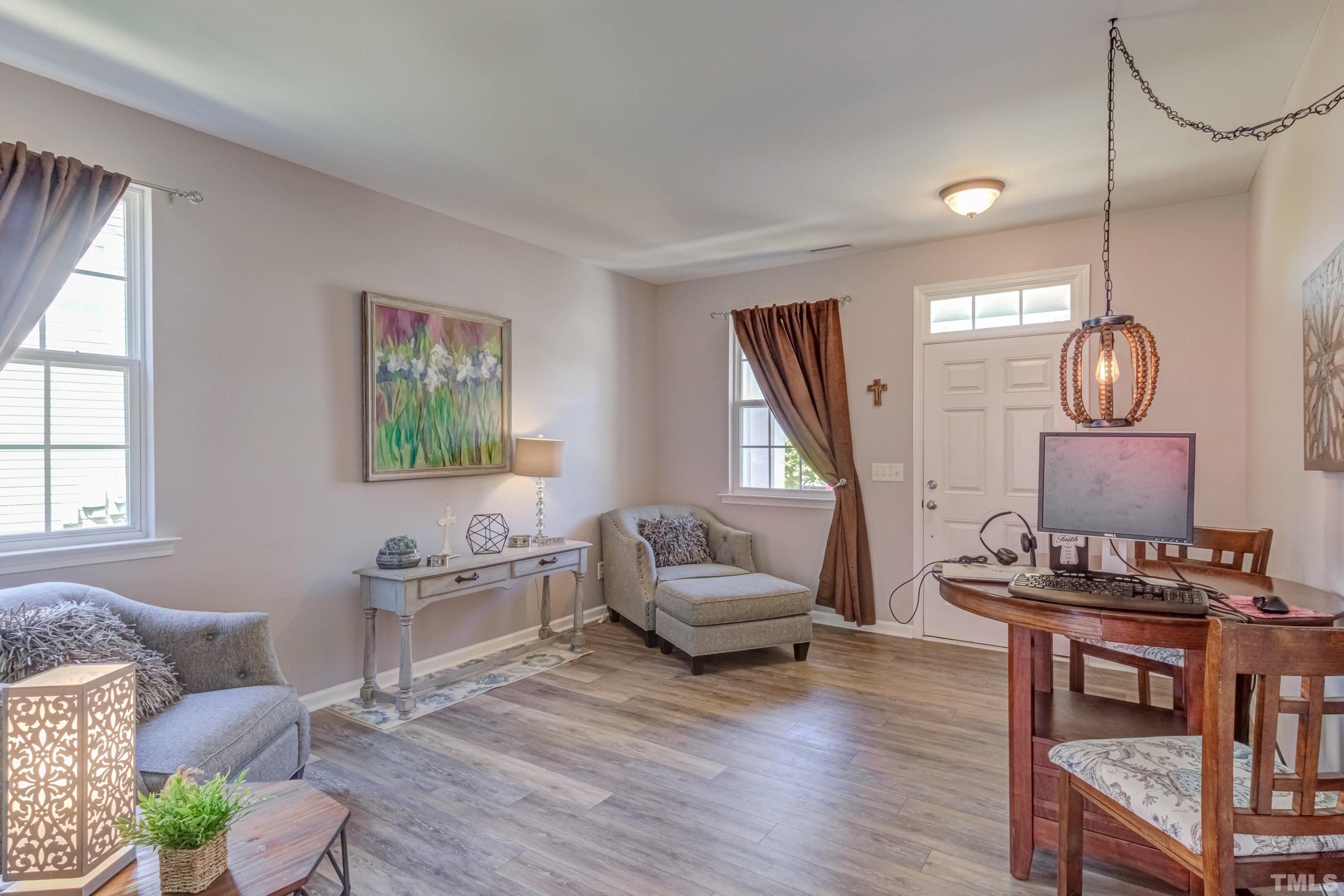 121 Ryder Cup Circle Raleigh, NC 27603 - Photo 5 of 43 a living room with furniture a rug and a window