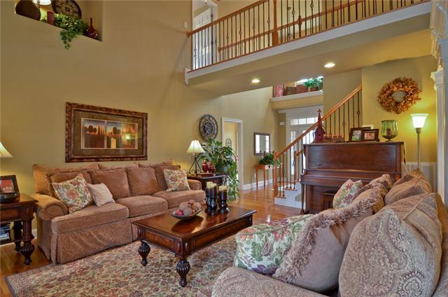 1224 White Rock Road Spring Hill, TN 37174 - Photo 14 of 15 a living room with furniture a rug and paintings on the wall