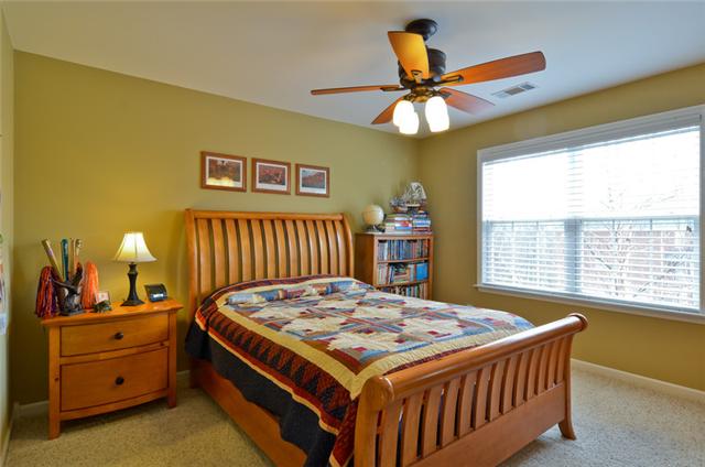 1224 White Rock Road Spring Hill, TN 37174 - Photo 8 of 15 a bedroom with a bed and a chandelier