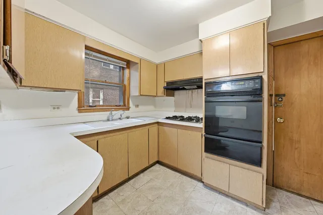 a kitchen with a refrigerator and a sink