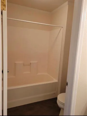 a bathroom with a shower and a toilet