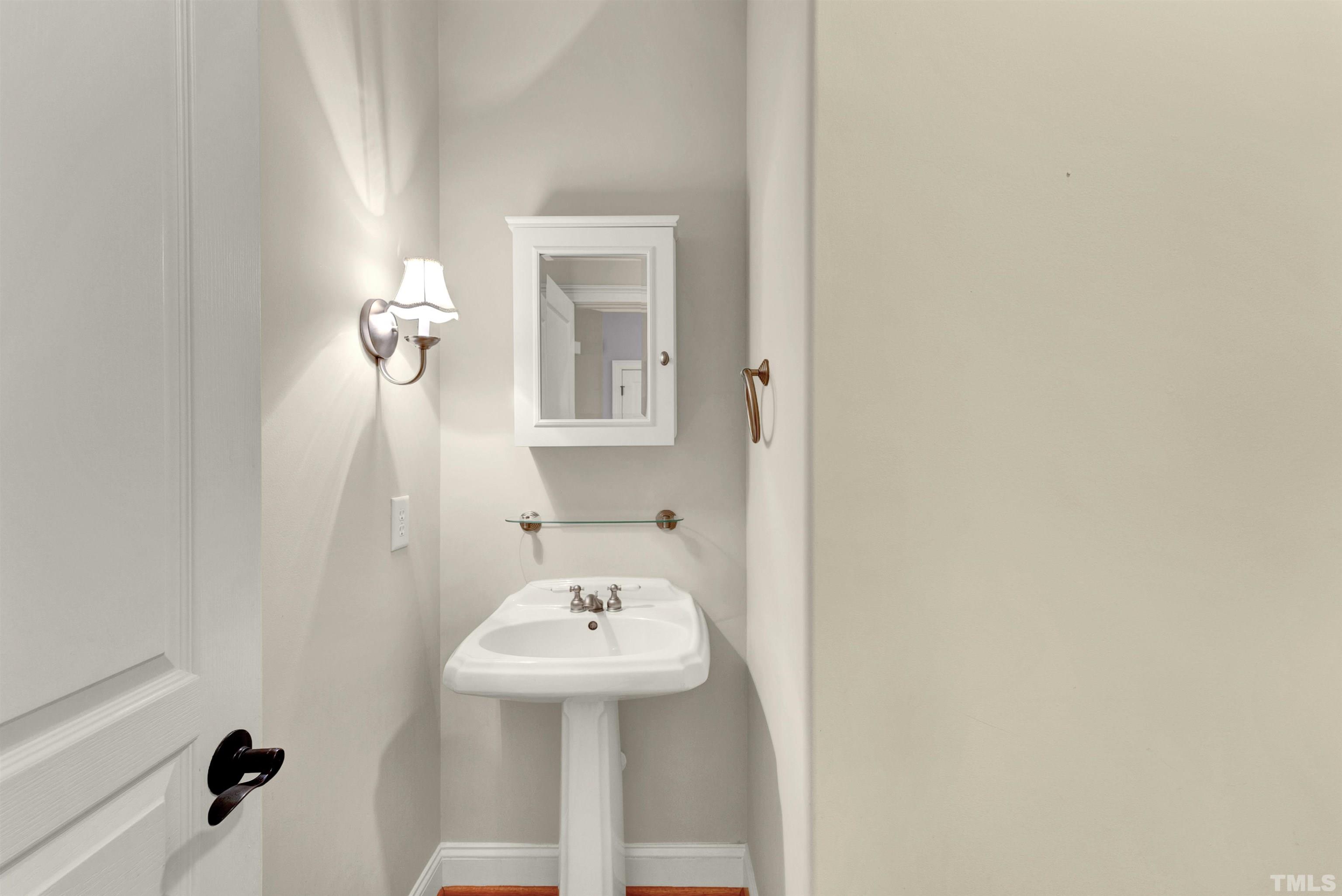 1201 Town Side Drive Apex, NC 27502 - Photo 13 of 40 a bathroom with a sink a toilet and mirror