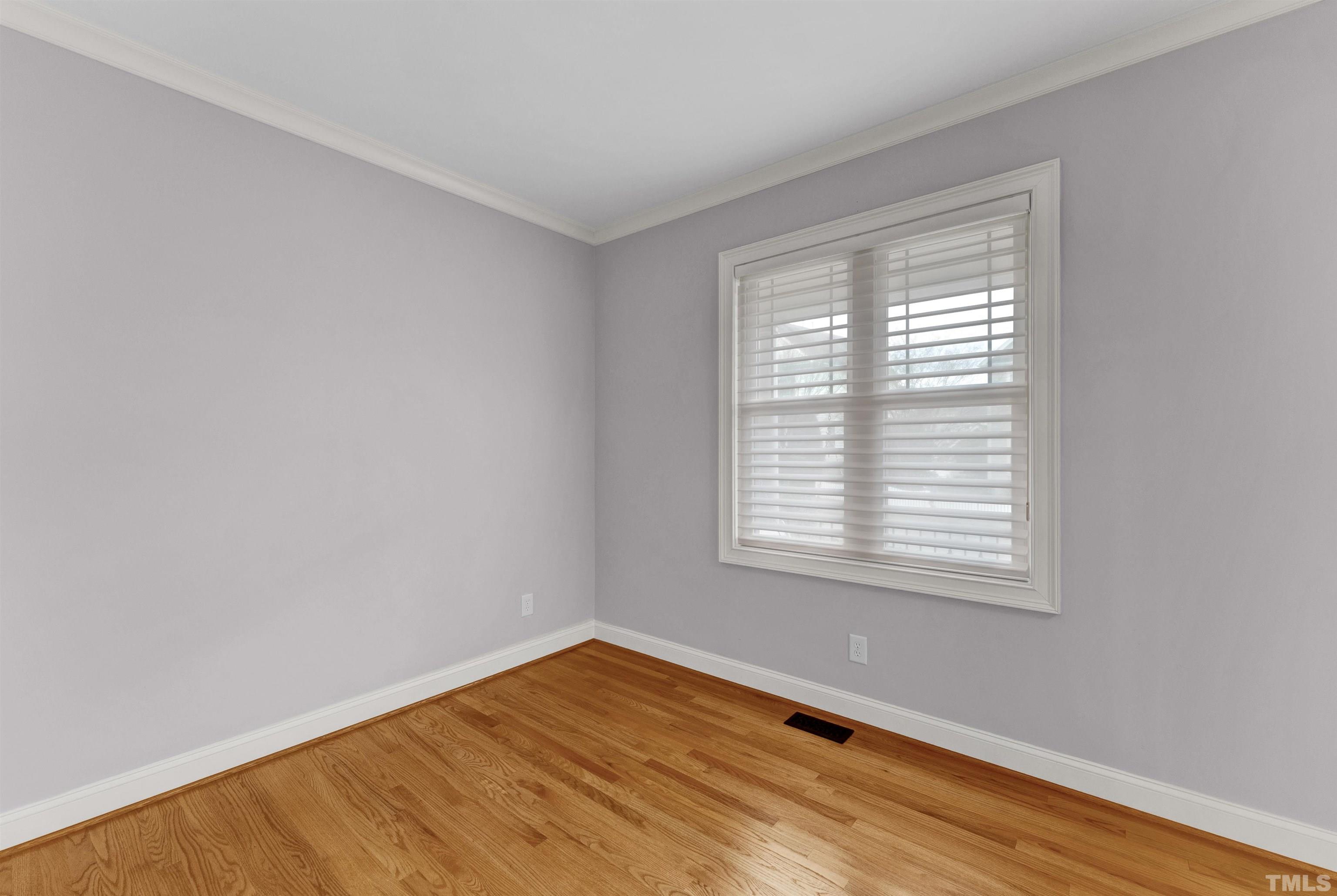 1201 Town Side Drive Apex, NC 27502 - Photo 14 of 40 a view of an empty room with wooden floor and a window