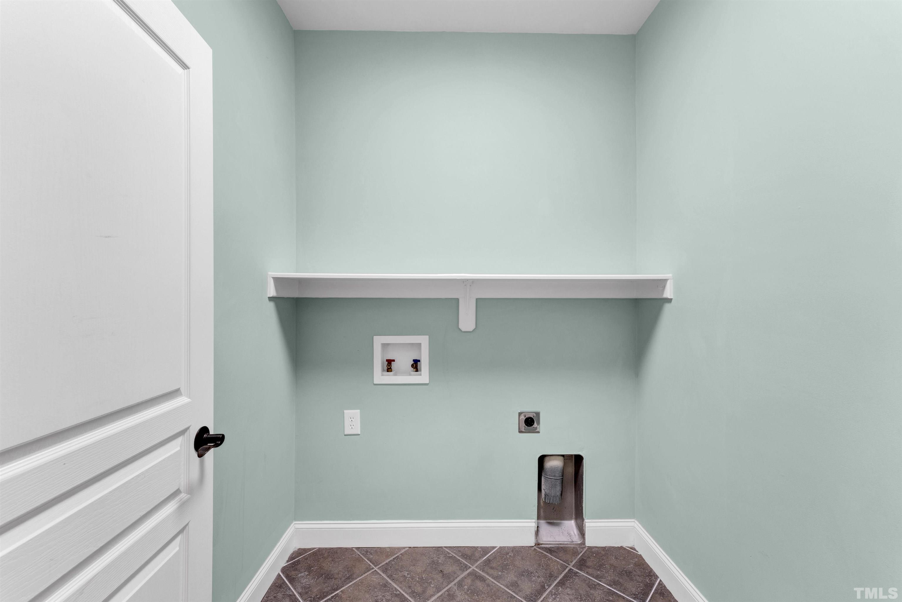 1201 Town Side Drive Apex, NC 27502 - Photo 18 of 40 a view of storage and utility room with wooden floor