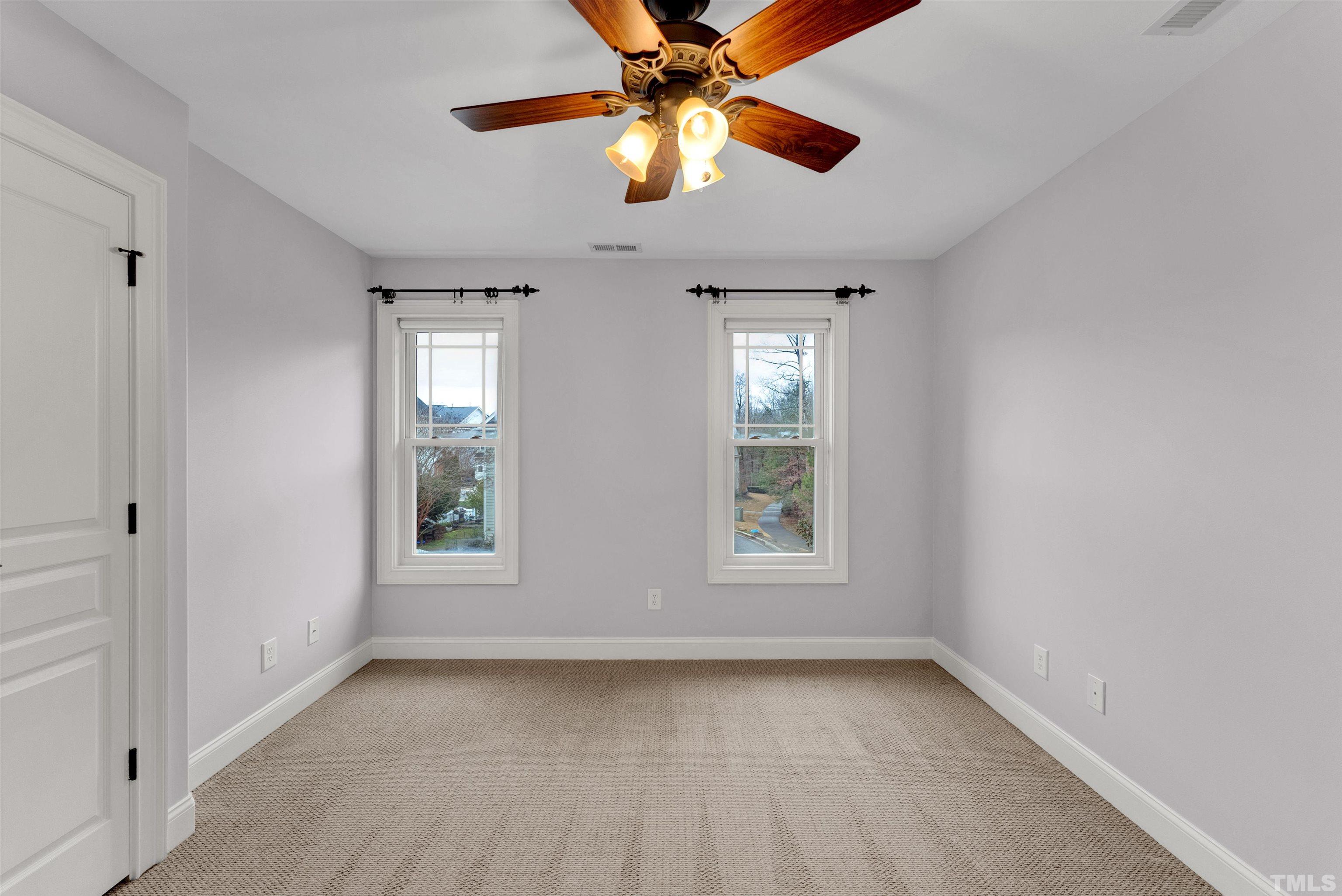 1201 Town Side Drive Apex, NC 27502 - Photo 31 of 40 an empty room with windows and fan