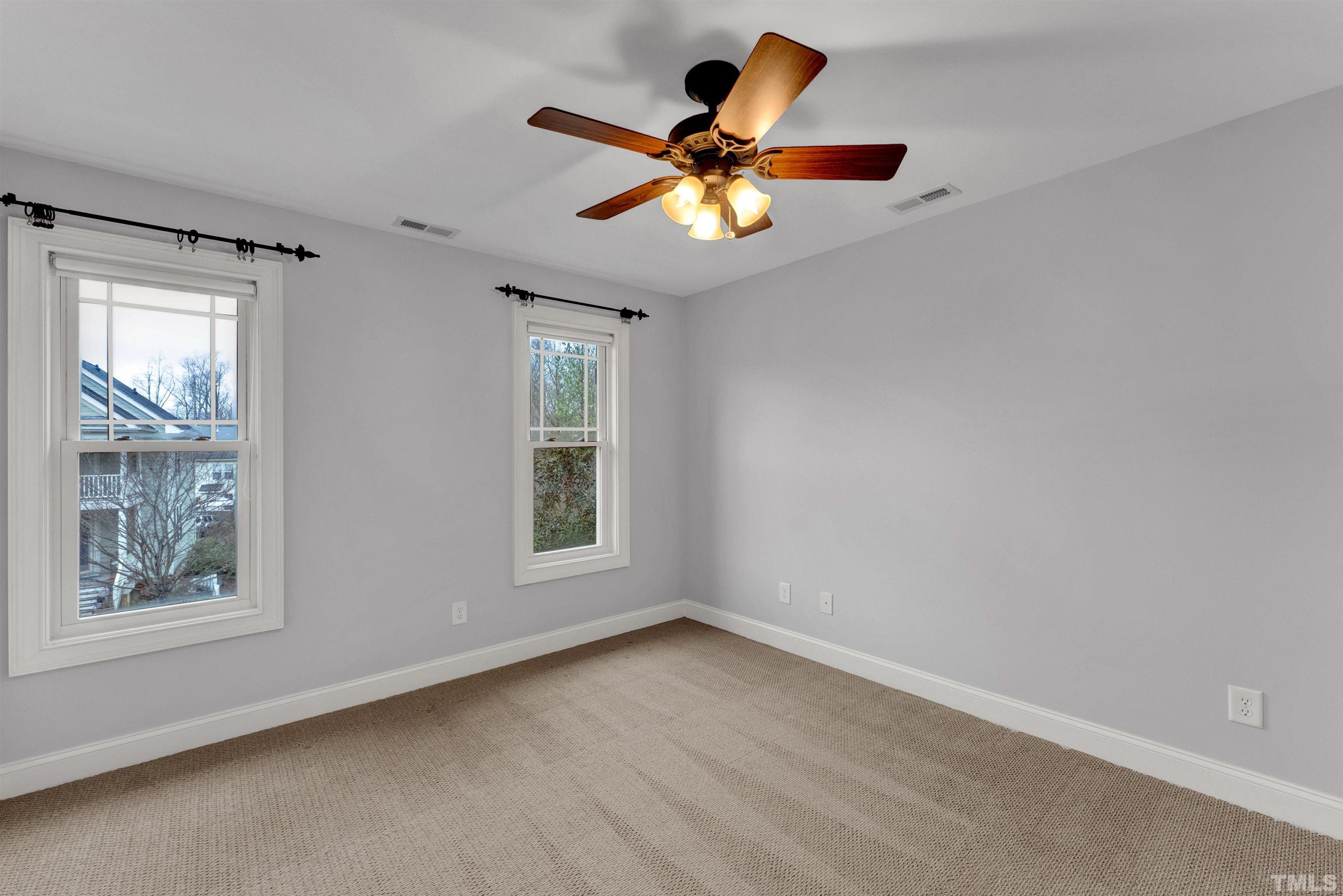 1201 Town Side Drive Apex, NC 27502 - Photo 33 of 40 an empty room with window and ceiling fan