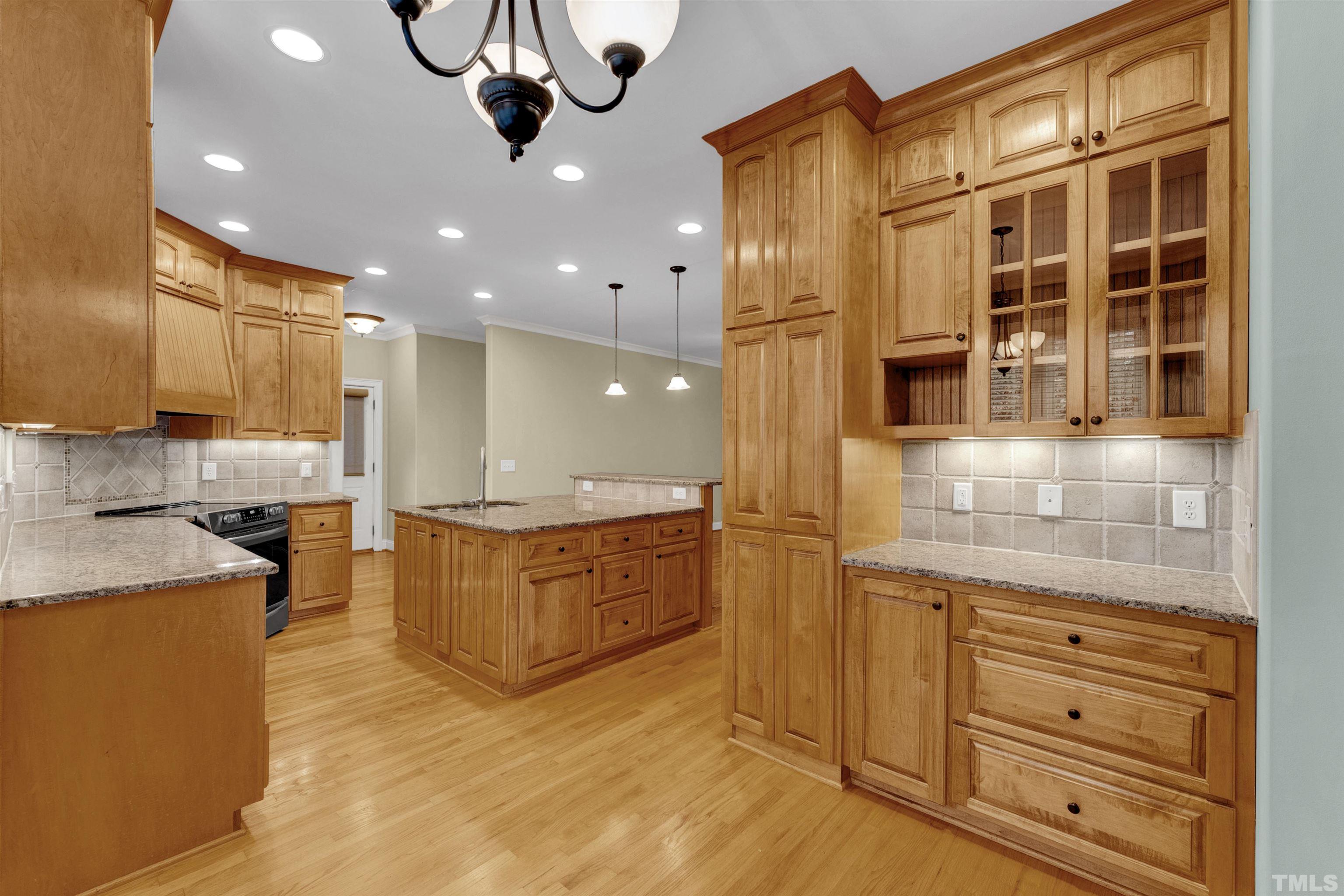 1201 Town Side Drive Apex, NC 27502 - Photo 5 of 40 a kitchen with stainless steel appliances granite countertop a stove and cabinets