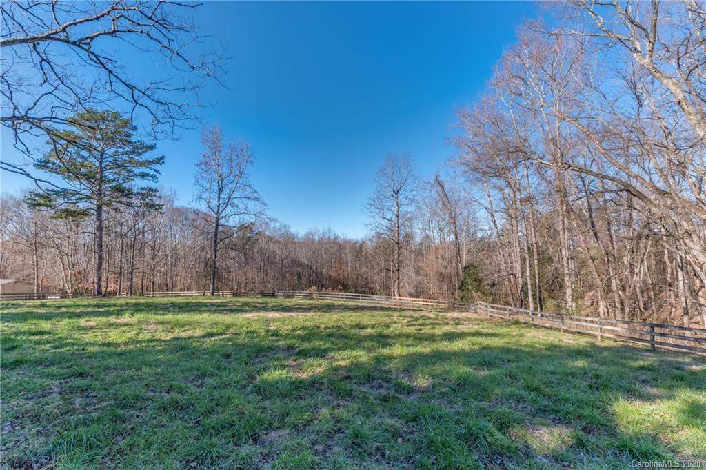 5975 Hunting Country Road Tryon, NC 28782 - Photo 2 of 47 a backyard of a house with lots of green space