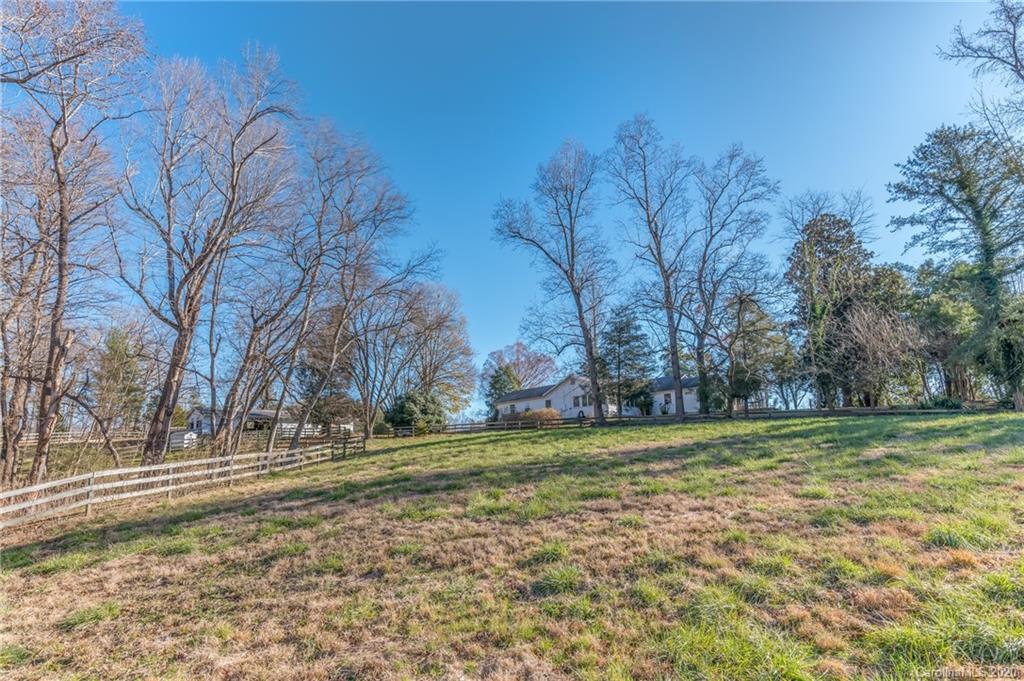 5975 Hunting Country Road Tryon, NC 28782 - Photo 12 of 47 a view of a field with large trees