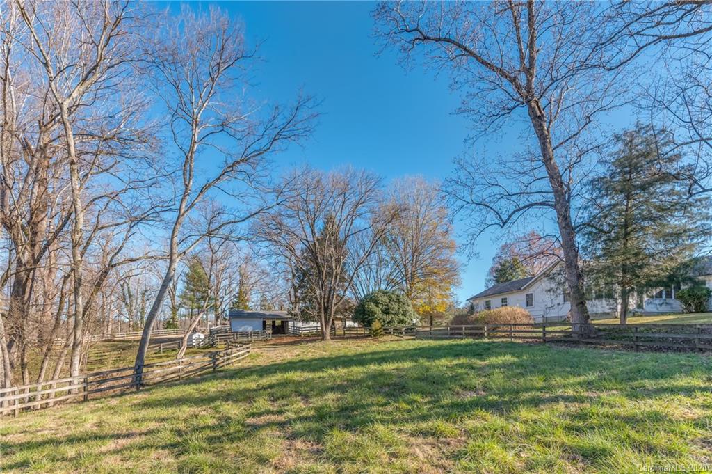 5975 Hunting Country Road Tryon, NC 28782 - Photo 13 of 47 a backyard of apartments with large trees