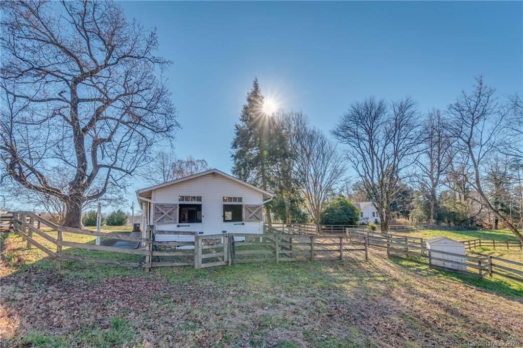 5975 Hunting Country Road Tryon, NC 28782 - Photo 15 of 47 a front view of a house with garden