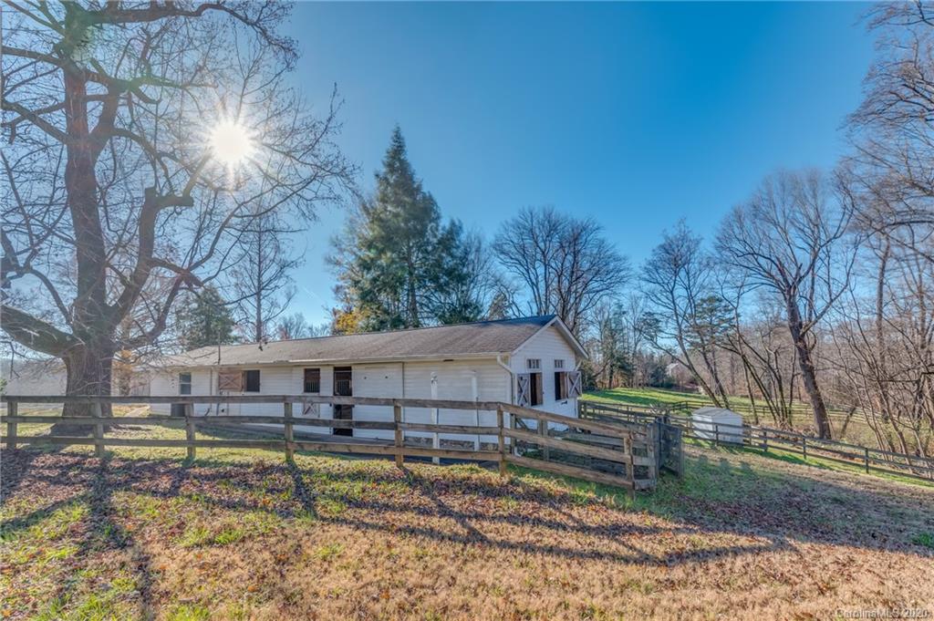 5975 Hunting Country Road Tryon, NC 28782 - Photo 16 of 47 a view of a house with a yard