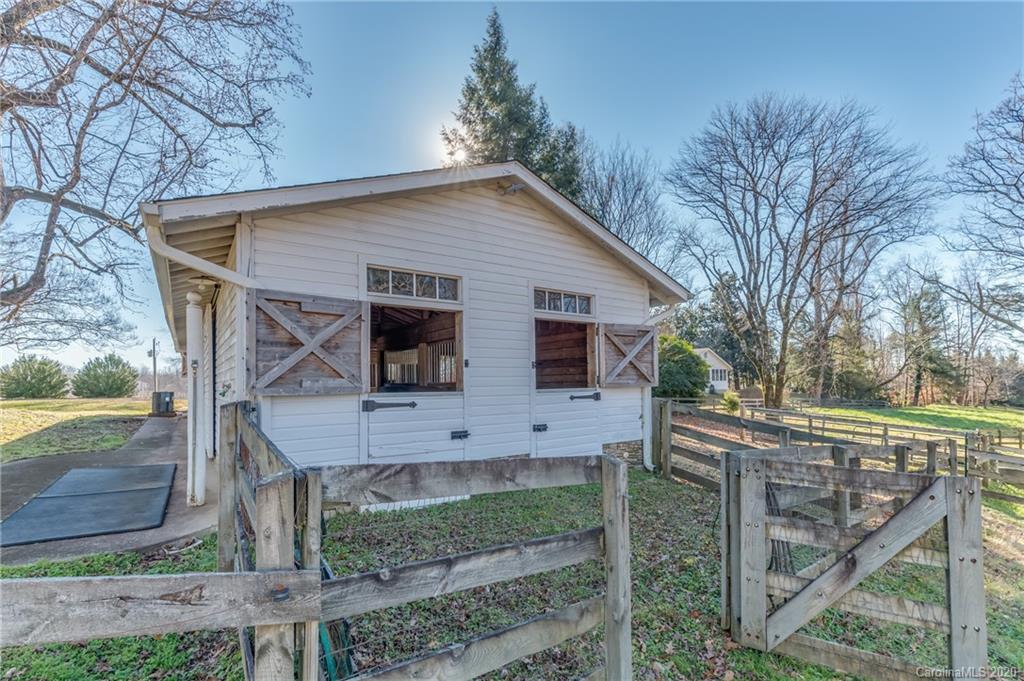 5975 Hunting Country Road Tryon, NC 28782 - Photo 17 of 47 a view of a house with wooden fence