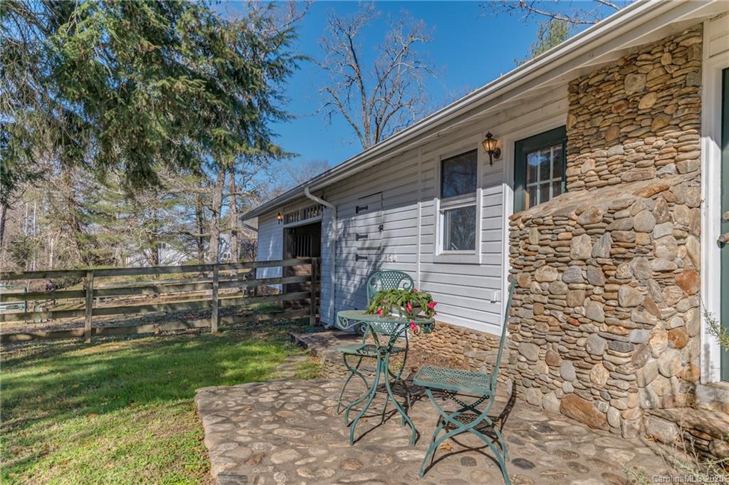 5975 Hunting Country Road Tryon, NC 28782 - Photo 22 of 47 a front view of a house with garden
