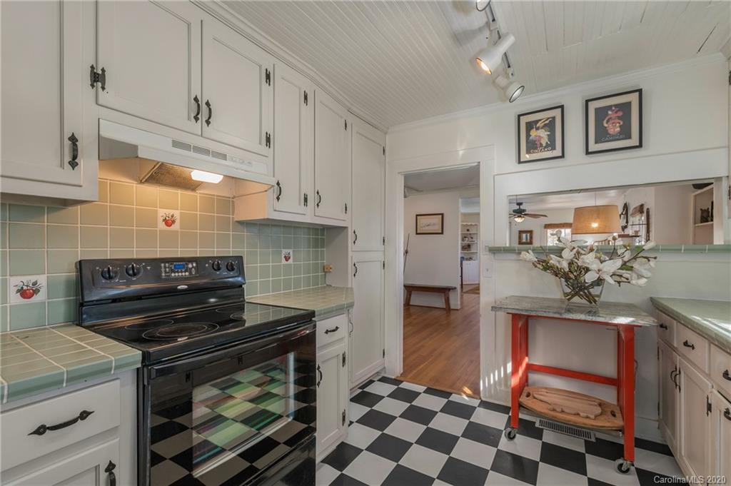5975 Hunting Country Road Tryon, NC 28782 - Photo 34 of 47 a kitchen with stainless steel appliances kitchen island granite countertop a stove a sink and a microwave