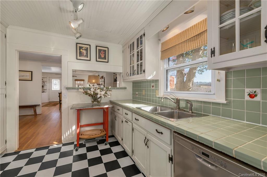 5975 Hunting Country Road Tryon, NC 28782 - Photo 35 of 47 a kitchen with a sink a stove cabinets and counter space
