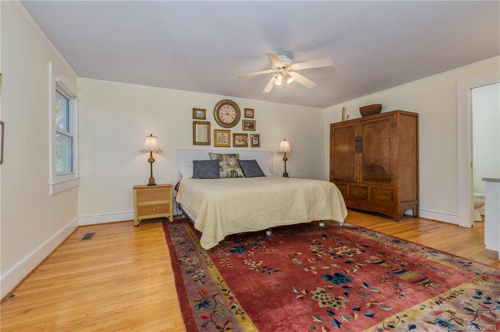 5975 Hunting Country Road Tryon, NC 28782 - Photo 40 of 47 a bedroom with a bed and a painting on the wall