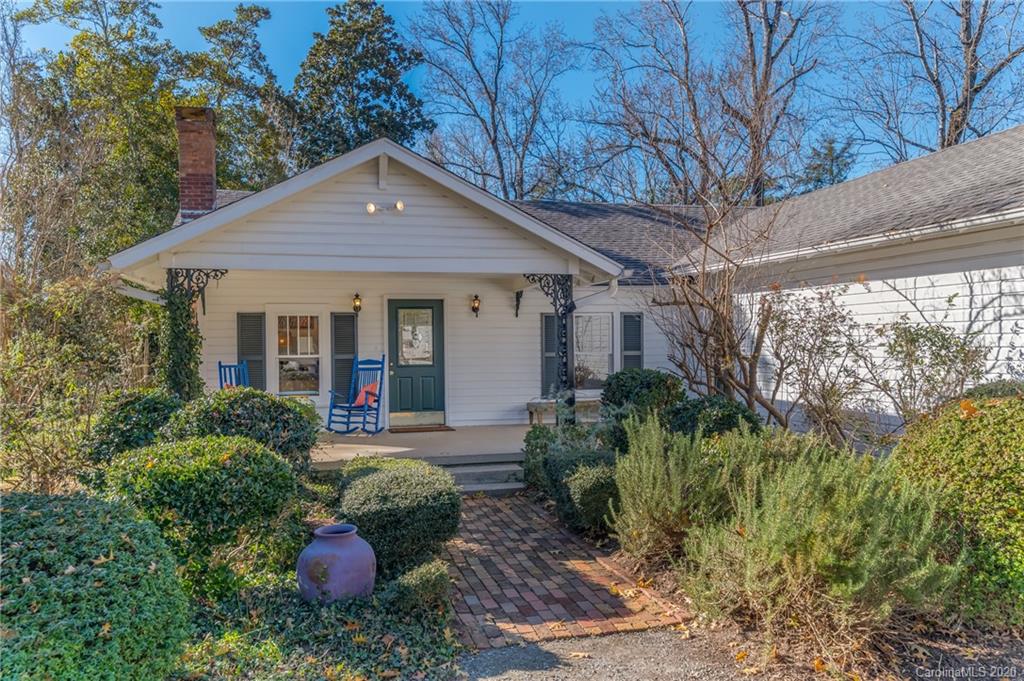 5975 Hunting Country Road Tryon, NC 28782 - Photo 47 of 47 a front view of a house with a yard and potted plants