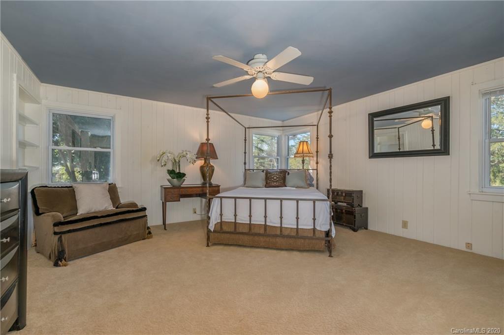 5975 Hunting Country Road Tryon, NC 28782 - Photo 6 of 47 a bedroom with furniture and a chandelier fan
