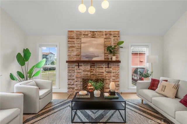 a living room with furniture a fireplace and a potted plant