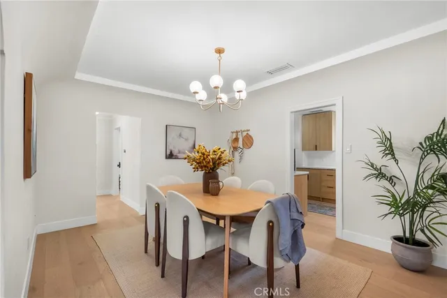 a dining room with furniture and chandelier