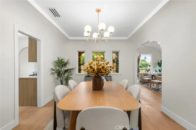 a view of a dining room with furniture and chandelier