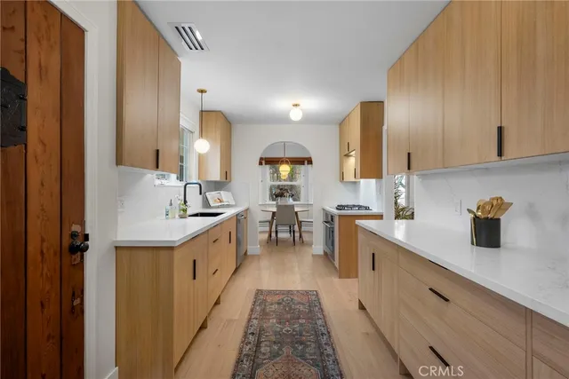 a large kitchen with a sink and cabinets