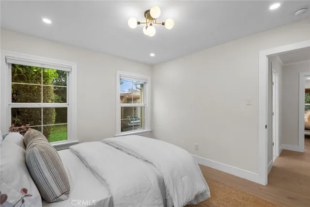 a bedroom with a bed ceiling fan and a window