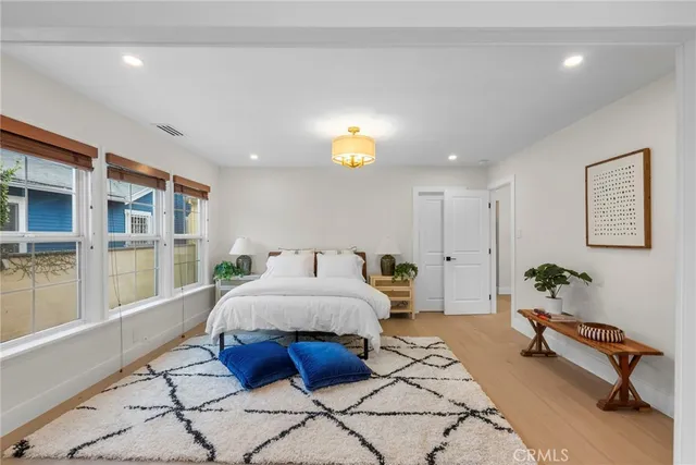 a spacious bedroom with a bed and a table in it