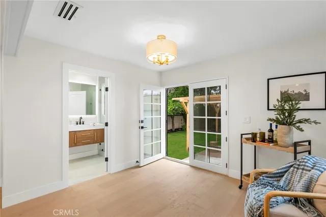 a view of a bedroom with furniture and window