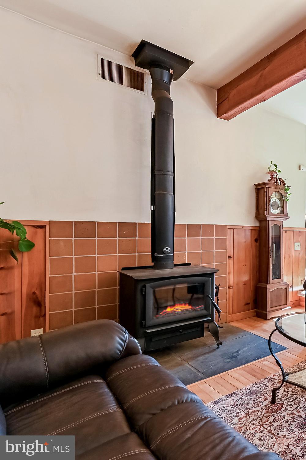 4921 Idlewilde Road Shady Side, MD 20764 - Photo 20 of 58 Warming Tile Hearth Wood Stove . Exposed Beam