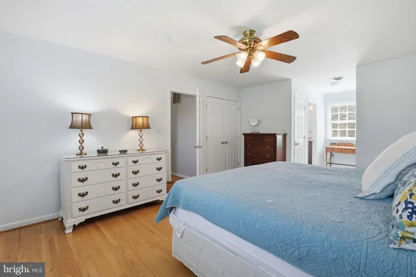 a bedroom with bed and wooden floor