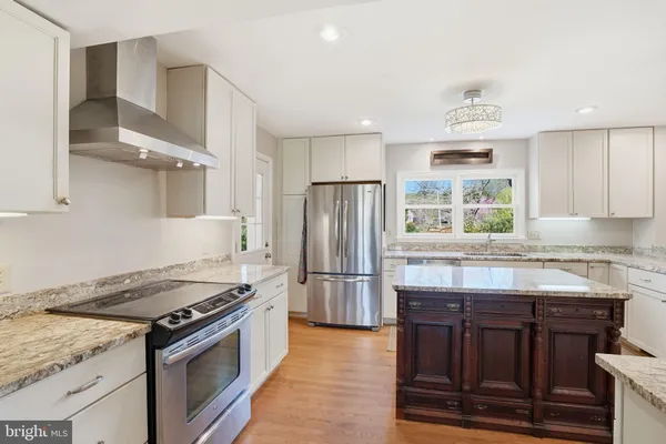 a kitchen with granite countertop a stove and a refrigerator