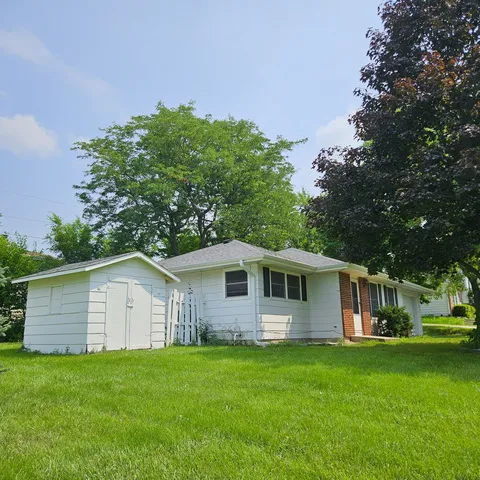 a front view of house with yard and green space